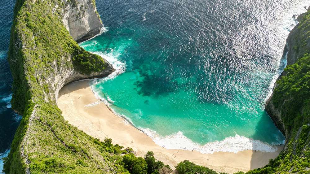 Bali’s white sand beaches attract travelers seeking sun and relaxation